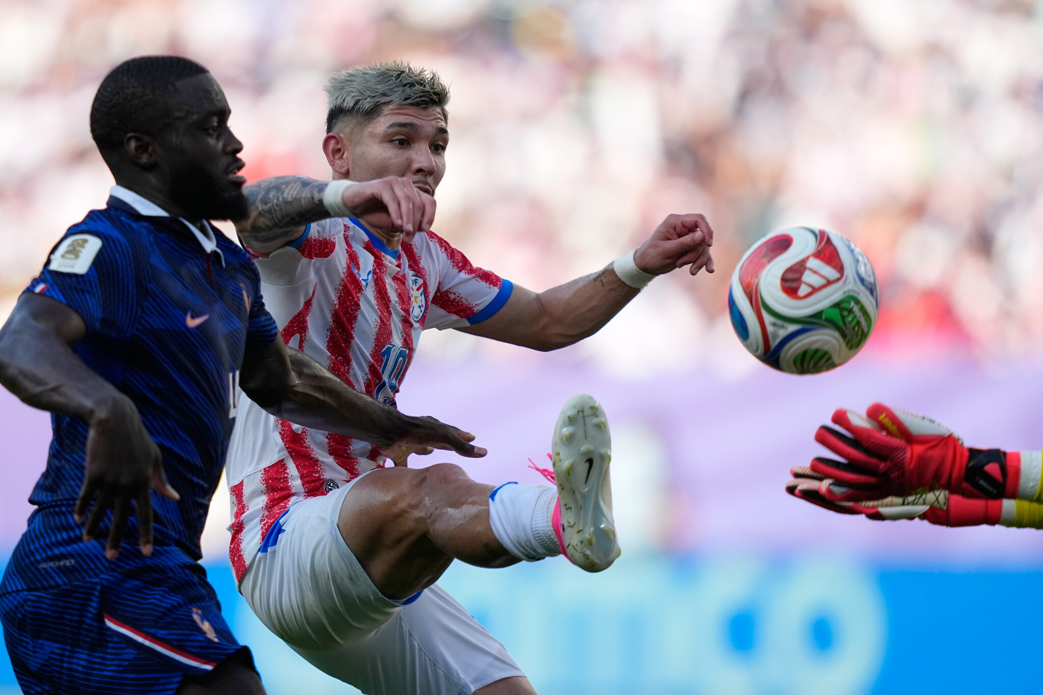 Archive photo: Julio Enciso challenges for the ball in a Paraguay shirt, pictured in the round-of-16 match against France (not this game). Source: Wikimedia Commons